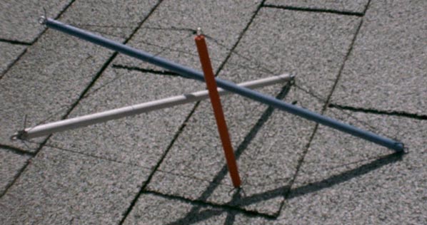 side view of skew red-silver-blue dowel-and-fishing-line tensegrity three-prism